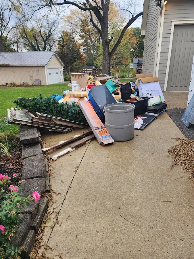 Dumpster being loaded with debris for Commercial Dumpster Rental in Somerville